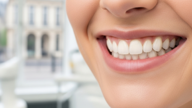 Close-up of a person's natural, healthy, and confident smile, showcasing perfectly aligned white teeth, set against a deeply blurred background of a modern dental clinic and a subtle, out-of-focus hint of French architecture. No text is visible.