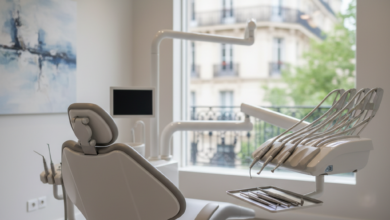 A modern and inviting dental treatment room with a comfortable chair, sleek instruments, and a blurred background suggesting a French city. The room is brightly lit with soft, natural light, conveying a sense of calm and advanced care.