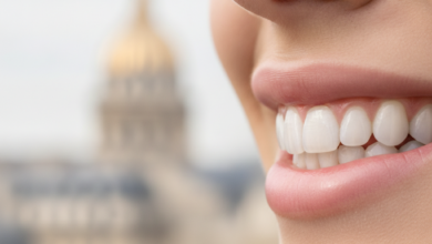 Close-up, photorealistic image of a perfect, bright white smile with natural-looking dental veneers, in sharp focus. The background is an extremely blurred, elegant Parisian street scene or iconic French architecture, illuminated by soft daylight.